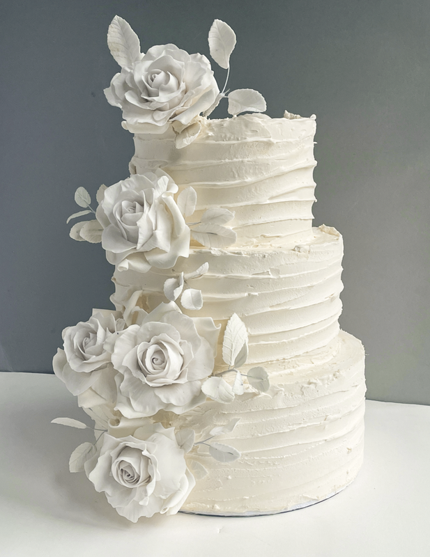 3 tier buttercream wedding cake with sugar flowers
